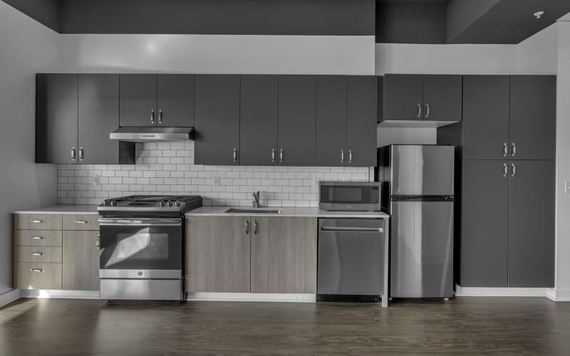 a kitchen with black cabinets