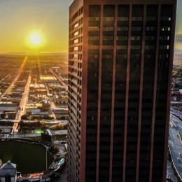 a tall building with a road and cars on the road
